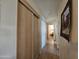 Hallway with light wood floors and linen closet with sliding doors at 8700 E University Dr # 1931, Mesa, AZ 85207