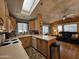 Open kitchen with island and view into living room at 8700 E University Dr # 1931, Mesa, AZ 85207