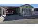 Mobile home exterior with carport and red truck parked at 8700 E University Dr # 1931, Mesa, AZ 85207