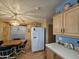 Kitchen boasts white appliances and a dinette area with a window view at 8700 E University Dr # 1931, Mesa, AZ 85207