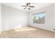 Comfortable bedroom with window and ceiling fan at 1367 E Desert Flower Ln, Phoenix, AZ 85048