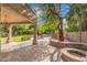 Landscaped backyard oasis with a covered patio and pool at 1367 E Desert Flower Ln, Phoenix, AZ 85048