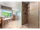 Modern bathroom with glass shower enclosure and tile flooring at 1367 E Desert Flower Ln, Phoenix, AZ 85048