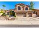 Two-story house with three-car garage and desert landscaping at 1367 E Desert Flower Ln, Phoenix, AZ 85048