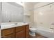 Neat bathroom with a shower/tub combo and wood vanity at 1367 E Desert Flower Ln, Phoenix, AZ 85048