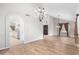 Open dining room with hardwood floors and views into kitchen and entryway at 1367 E Desert Flower Ln, Phoenix, AZ 85048