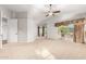 Large bedroom with carpeted floors and access to a private balcony at 1367 E Desert Flower Ln, Phoenix, AZ 85048