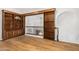 Spacious library with built-in wooden bookshelves and hardwood floors at 1367 E Desert Flower Ln, Phoenix, AZ 85048