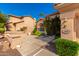 Front entry with stone pathway, mature shrubs, and a light fixture at 1367 E Desert Flower Ln, Phoenix, AZ 85048