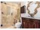 Elegant bathroom with a walk-in shower, granite vanity, and ornate mirror at 1367 E Desert Flower Ln, Phoenix, AZ 85048