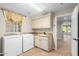 Bright laundry room with washer, dryer and access to the backyard at 1367 E Desert Flower Ln, Phoenix, AZ 85048
