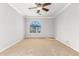 Bright bedroom with arched window and ceiling fan at 1367 E Desert Flower Ln, Phoenix, AZ 85048