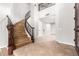 Grand staircase with wood railing leading to the upper level at 1367 E Desert Flower Ln, Phoenix, AZ 85048
