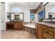 Elegant bathroom with double vanity, soaking tub, and view at 1367 E Desert Flower Ln, Phoenix, AZ 85048