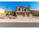 Two-story house with three-car garage and desert landscaping at 1367 E Desert Flower Ln, Phoenix, AZ 85048