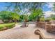 Landscaped backyard oasis with pool and built-in kitchen at 1367 E Desert Flower Ln, Phoenix, AZ 85048
