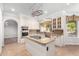 Updated kitchen with granite countertops, white cabinets and island at 1367 E Desert Flower Ln, Phoenix, AZ 85048