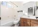 Clean bathroom with a bathtub, toilet and wooden vanity at 1367 E Desert Flower Ln, Phoenix, AZ 85048