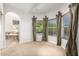 Bedroom with bay window, access to bathroom, and view of backyard at 1367 E Desert Flower Ln, Phoenix, AZ 85048