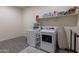 Laundry room with washer, dryer, and storage shelves at 22842 E Via Las Brisas Vly, Queen Creek, AZ 85142