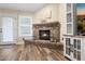 Brick fireplace with a rustic mantle in the living room at 7207 N 175Th Ave, Waddell, AZ 85355