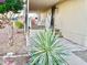 Mobile home with a covered porch and nicely landscaped front yard at 9427 E University Dr # 100, Mesa, AZ 85207