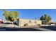 Tan mobile home with attached garage and landscaping at 9427 E University Dr # 100, Mesa, AZ 85207
