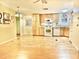 Kitchen with light wood cabinets, white appliances and laminate wood floors at 9427 E University Dr # 100, Mesa, AZ 85207