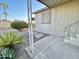 Side view of the mobile home with covered patio and landscaping at 9427 E University Dr # 100, Mesa, AZ 85207