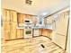 Efficient kitchen with light wood cabinets and appliances at 9427 E University Dr # 100, Mesa, AZ 85207