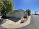 Mobile home with attached garage and street view at 9427 E University Dr # 100, Mesa, AZ 85207