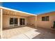 Covered patio with tile flooring and sliding glass doors at 10477 W Highwood Ln, Sun City, AZ 85373