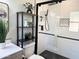 Modern bathroom with black and white tile and glass shower at 4442 E Aire Libre Ave, Phoenix, AZ 85032