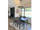 Bright dining room with dark wood table, chandelier, and pool view at 4442 E Aire Libre Ave, Phoenix, AZ 85032
