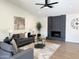 Spacious living room with a fireplace and comfy seating area at 4442 E Aire Libre Ave, Phoenix, AZ 85032