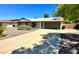 Single-story home with a driveway, attached garage, and landscaping at 4442 E Aire Libre Ave, Phoenix, AZ 85032