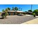 Single-story home with a well-maintained front yard and rock landscaping at 4442 E Aire Libre Ave, Phoenix, AZ 85032