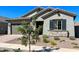 One-story home with gray siding, stone accents, and landscaping at 15922 W Electra Ln, Surprise, AZ 85379
