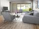 Living room with gray couches, coffee table, and view of backyard at 15922 W Electra Ln, Surprise, AZ 85379