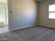 Simple bedroom with gray carpet and an ensuite bathroom at 15922 W Electra Ln, Surprise, AZ 85379