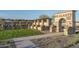 Elegant community entrance with stone archway and landscaping at 15922 W Electra Ln, Surprise, AZ 85379