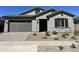 One-story home with gray siding, stone accents, and landscaping at 15922 W Electra Ln, Surprise, AZ 85379