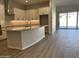 Open kitchen with island and access to backyard at 15922 W Electra Ln, Surprise, AZ 85379
