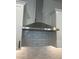 Stainless steel range hood over white cabinets at 15922 W Electra Ln, Surprise, AZ 85379