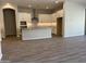 Open kitchen with island, granite countertops, and stainless steel appliances at 15922 W Electra Ln, Surprise, AZ 85379