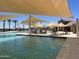 Large pool with shaded seating and tables at 15922 W Electra Ln, Surprise, AZ 85379