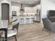 Modern kitchen with white cabinets, granite island, and stainless steel appliances at 15922 W Electra Ln, Surprise, AZ 85379