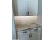 White shaker kitchen cabinets with black hardware and granite countertop at 15922 W Electra Ln, Surprise, AZ 85379