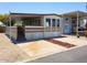 Mobile home exterior with covered carport and mature landscaping at 17200 W Bell Rd # 450, Surprise, AZ 85374