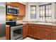 Kitchen with stainless steel appliances and wood cabinets at 1446 E Grovers Ave # 26, Phoenix, AZ 85022